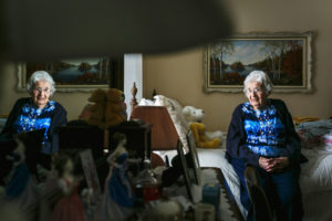 Elderly Woman Sitting on a Bed